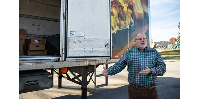 Ben Kirtley, coordinator of Family Resource and Youth Services Centers for Warren County Public Schools, talks about the turkey drive the school district is hosting beside a refrigerated truck trailer containing a few dozen turkeys already collected at the WCPS central office on Friday, Nov. 8, 2024. WCPS is partnering with local organizations, as well as seeking frozen turkey and chicken from community members, to provide Thanksgiving meals to families of students. (Grace McDowell/gtrace.mcdowell@bgdailynews.com)