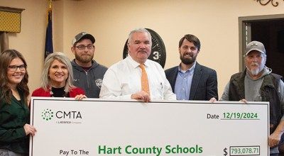 Hart County Schools Student Representative Emma Sanders, HCS School Board Vice Chairman Tina Rutledge, HCS School Board Member Tyler Holthouser, HCS Superintendent Nathan Smith, CMTA Project Manager Jason Pollan and HCS School Board Member Wesley Hodges pose for a picture with a $793,078.71 ceremonial check at the school board’s Thursday meeting, representing funds of the same amount earned through the installation of a geothermal well field.