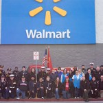 Toys for Tots volunteers stand for a picture in front of the Walton Avenue Walmart at Saturday’s Hand It To A Hero event.