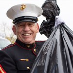 Malcolm Cherry, a veteran U.S. Marine and the commander of the local Post 23 of the American Legion, carries a bag of donations at Toys for Tots' Hand It To A Hero event Saturday at the Walton Avenue Walmart.
