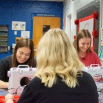 Warren East High School students Avery Gidcumb, Taylor Mills and Jamie Phelps sew ChemoComfort products Nov. 26 in their schools culinary lab. (David Mamaril Horowitz)