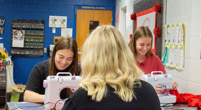 Warren East High School students Avery Gidcumb, Taylor Mills and Jamie Phelps sew ChemoComfort products Nov. 26 in their schools culinary lab. (David Mamaril Horowitz)