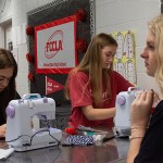 Warren East High School students Avery Gidcumb, Jamie Phelps and Taylor Mills work on ChemoComfort shirts at their school's culinary lab on Nov. 26.
