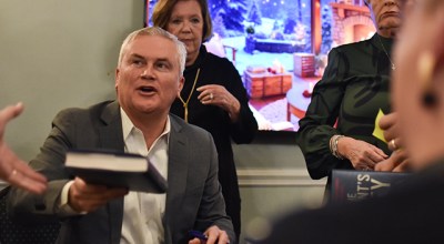 U.S. Rep. James Comer, R-Kentucky, chairman of the House Oversight Committee, hands a signed copy of his book “All the President’s Money” to an attendee at his Friday book-signing at the Bowling Green Country Club.