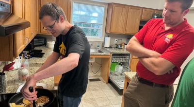 LifeWorks Transition Academy participants work on independent living skills, such as cooking, on a regular basis with support from staff. Second-year participant Joseph Felkins (left) learns to make pancakes with support from Program Director Hendrix Brakefield in the community kitchen at LifeWorks.