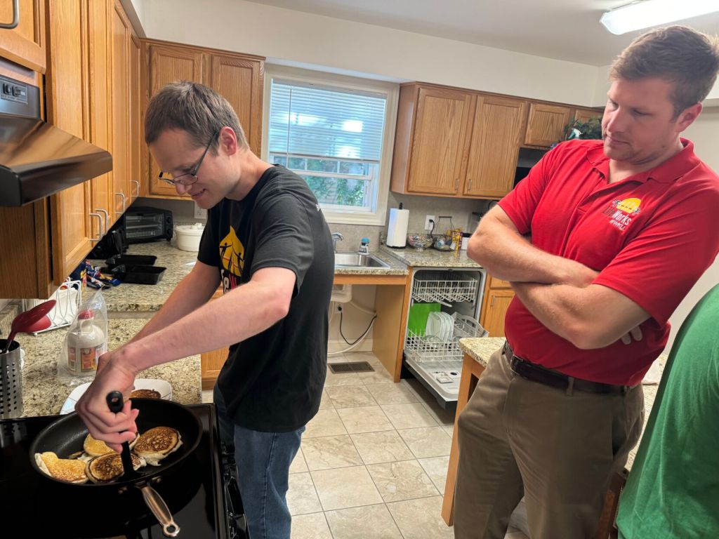 LifeWorks Transition Academy participants work on independent living skills, such as cooking, on a regular basis with support from staff. Second-year participant Joseph Felkins (left) learns to make pancakes with support from Program Director Hendrix Brakefield in the community kitchen at LifeWorks.