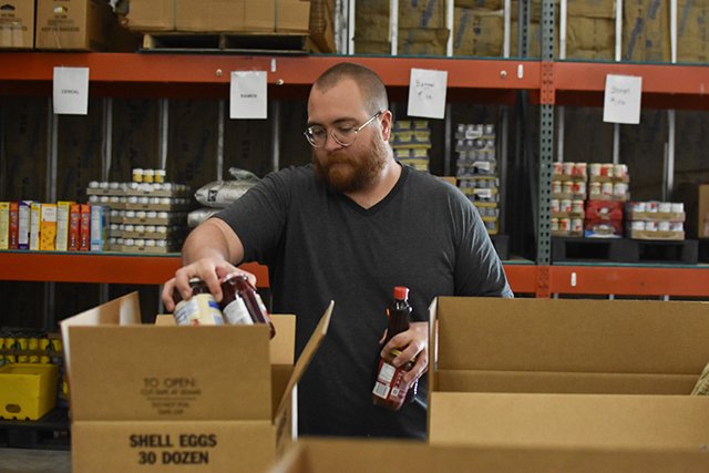 Tim Witthuhn, from State Street United Methodist Church, picks up food at House on the Hill Inc — non-perishables donated within Warren County through United Way of Southern Kentucky's Feed the Need food drive.