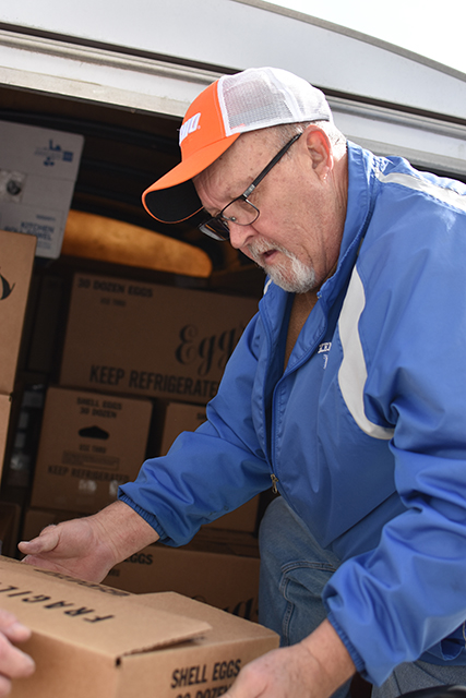 Steve Jenkins, of Calvary Baptist Church, on Tuesday loads food into a vehicle outside House on the Hill — non-perishables donated within Warren County through United Way of Southern Kentucky's Feed the Need food drive.