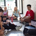 Picture of Sarah Schmitt teaching students chemistry ahead of an exercise where they'll make a rocket out of a Pepsi bottle, vinegar and baking soda.