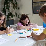 Picture of three in the MIT Spokes program creating Caesarean ciphers.