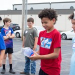 Picture of Rivez Myers, 10, holding onto a Pepsi bottle that’ll be turned into a rocket with vinegar and baking soda Monday.