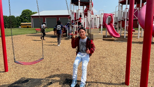 Picture of then-Teranga Academy student Ernesto Manuel-Andres sits on a swing at Chaney's Dairy Barn during a field trip last summer. (SUBMITTED)