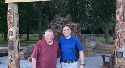 Picture of Randall Thornhill and his son, Natcher Elementary principal Matt Thornhill, standing for a picture underneath the sign for the J.J. the Jaguar Giant sculpture.