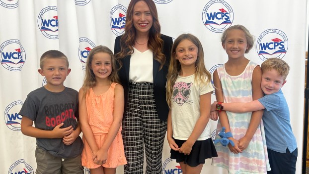 Picture of Lacey Hickey, the new principal of Richardsville Elementary, standing beside students at the July 17 announcement of her role.