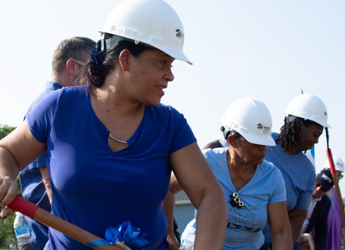Photo of local resident Irilai Sant Felix and others participating in a ceremonial groundbreaking for six affordable Habitat for Humanity homes.. (DAVID MAMARIL HOROWITZ)
