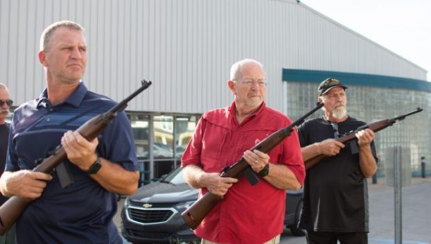 Photograph of Kip Black (from left) directing Jason Tippett, Richard Ewald and Gerald Head through the three-volley military salute as the Logan County veterans, alongside other members of the Logan County Honor Guard, hold their weekly practice Thursday in Russellville.