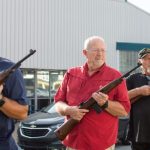 Photograph of Kip Black (from left) directing Jason Tippett, Richard Ewald and Gerald Head through the three-volley military salute as the Logan County veterans, alongside other members of the Logan County Honor Guard, hold their weekly practice Thursday in Russellville.
